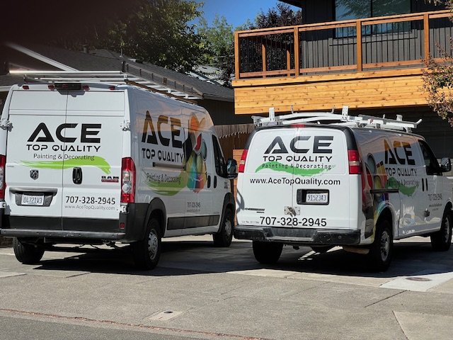 Ace Top Quality painting vans parked at a job site